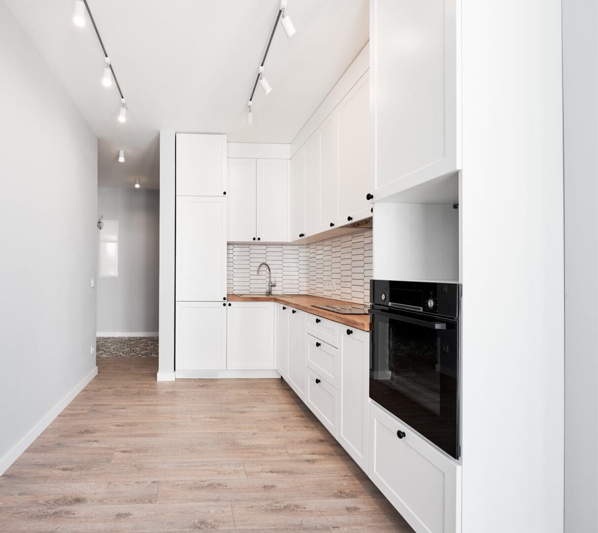 Photo collage of old apartment and new renovated room with parquet floor, kitchen counter, stove and white kitchen furniture. Concept of home renovation, restoration and refurbishment.